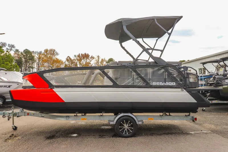 Slide: The Image of 2024 Sea-Doo Switch Sport 21 pontoon boat on trailer, featuring sleek design and canopy. - 5
