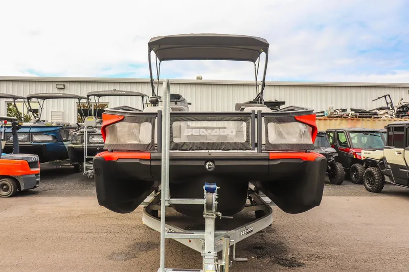 Slide: The Image of 2024 Sea-Doo Switch Sport 21 pontoon boat on trailer, rear view in a storage lot. - 7