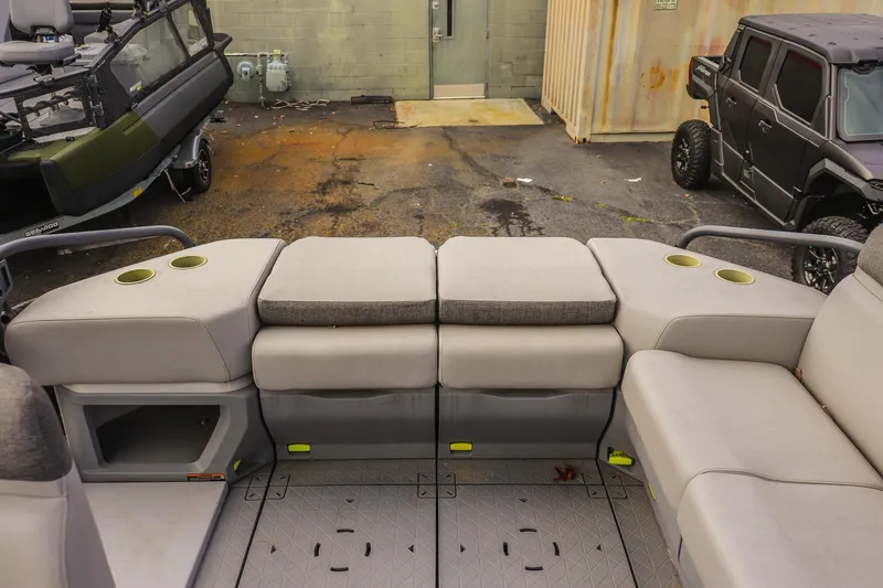 Slide: The Image of 2024 Sea-Doo Switch Sport 21 interior with cushioned seating and cup holders. - 9