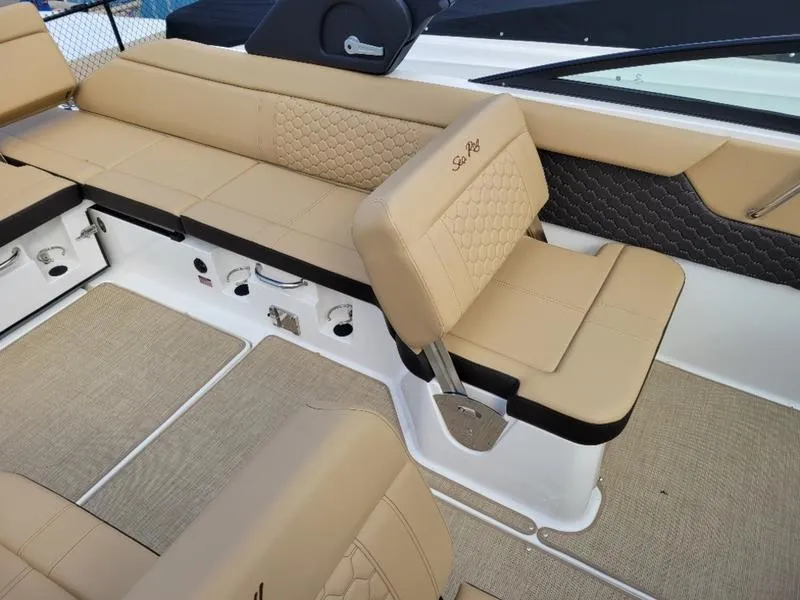 Slide: The Image of 2024 Sea Ray SDX 250 Outboard boat interior with tan seating and modern design. - 10