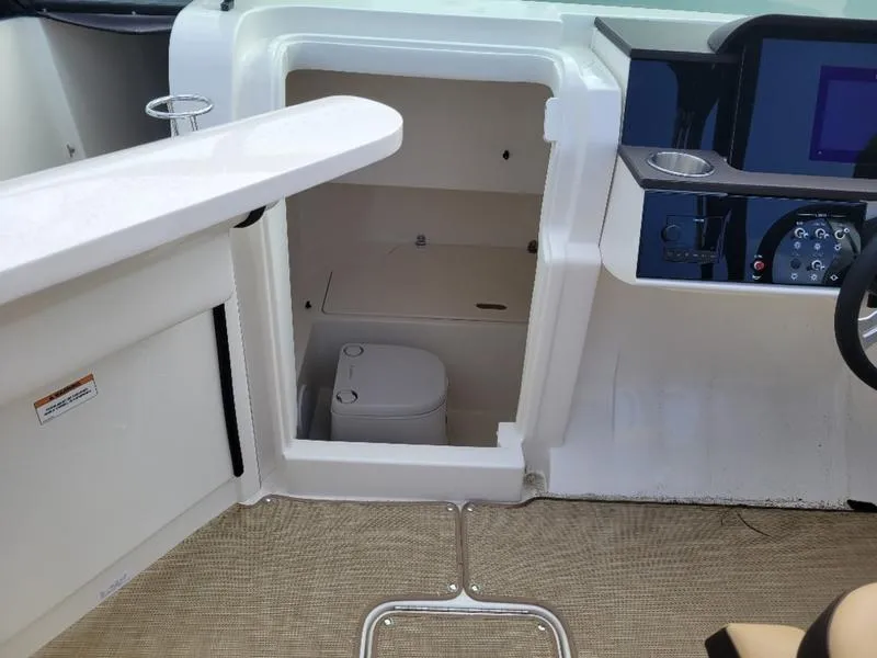 Slide: The Image of 2024 Sea Ray SDX 250 Outboard boat interior with a compact toilet compartment. - 12