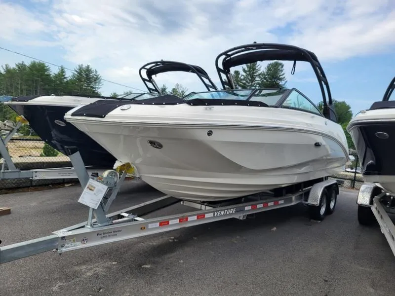 Slide: The Image of 2024 Sea Ray SDX 250 Outboard boat on a Venture trailer, parked outdoors. - 3