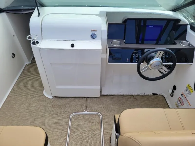 Slide: The Image of 2024 Sea Ray SDX 250 Outboard helm with modern controls and beige seating. - 5
