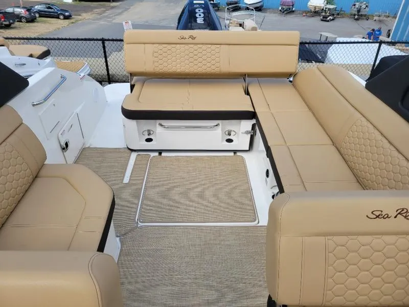 Slide: The Image of 2024 Sea Ray SDX 250 Outboard boat interior with tan seating and spacious layout. - 9