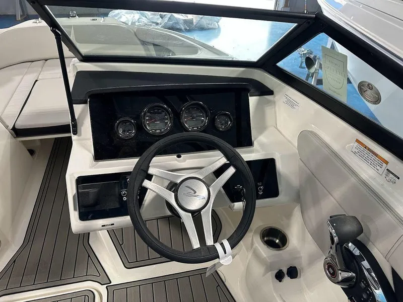 Slide: The Image of 2024 Sea Ray 210 SPX OB boat dashboard with steering wheel and control panel. - 12