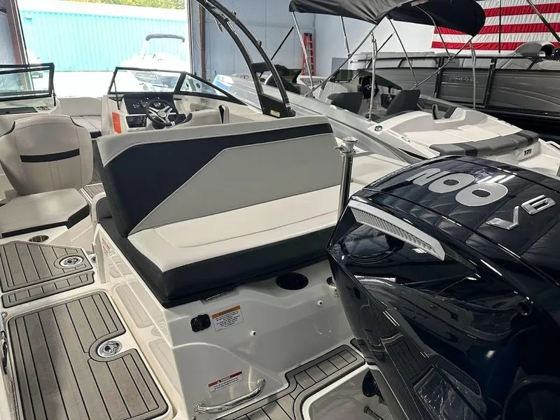 Slide: The Image of 2024 Sea Ray 210 SPX OB boat interior with seating and V6 outboard engine. - 2