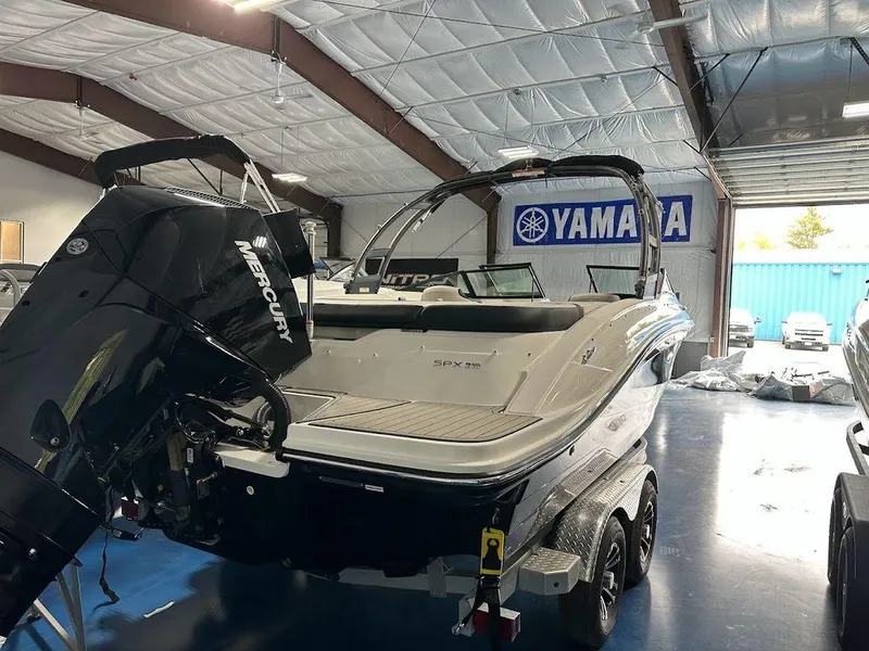 Slide: The Image of 2024 Sea Ray 210 SPX OB boat with Mercury outboard engine in showroom. - 4