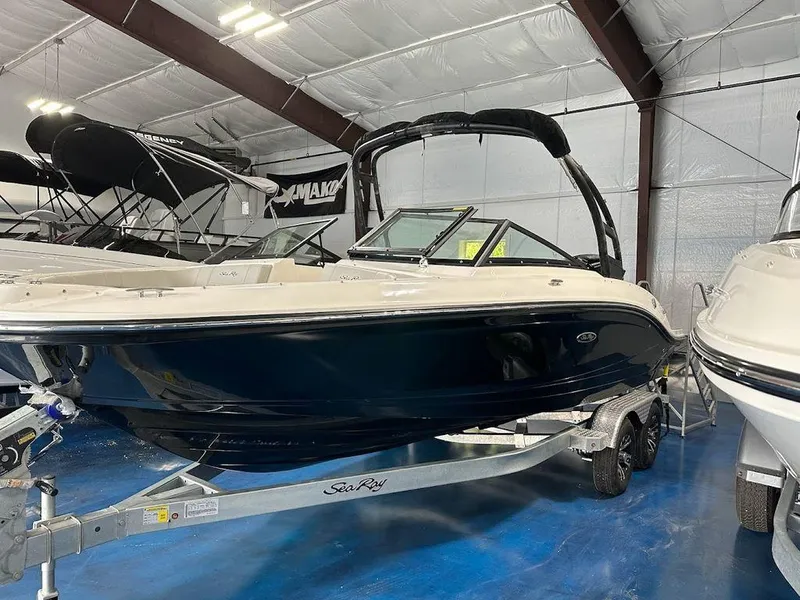 Slide: The Image of 2024 Sea Ray 210 SPX OB boat on a trailer in a showroom. - 8
