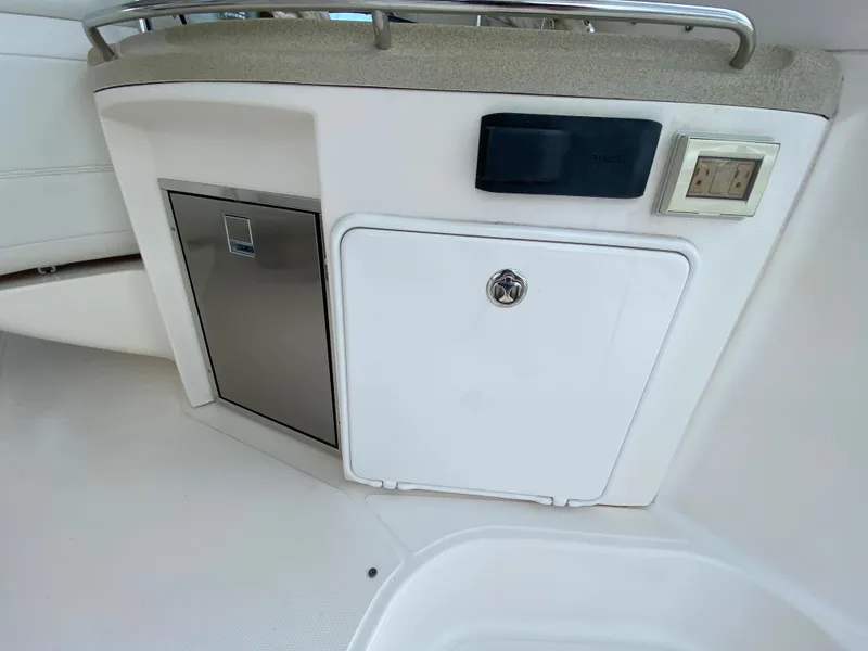 Slide: The Image of 2004 Regal 3860 Commodore boat interior storage compartments and control panel. - 11