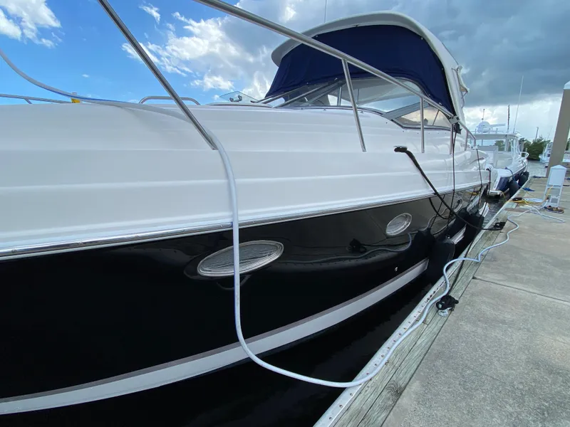 Slide: The Image of 2004 Regal 3860 Commodore yacht docked at marina. - 14