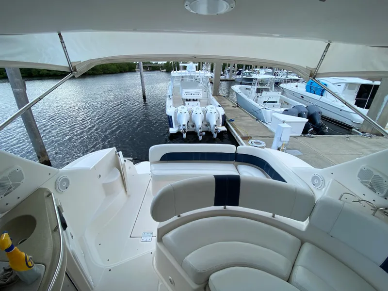 Slide: The Image of 2004 Regal 3860 Commodore yacht docked at marina, rear seating view. - 19