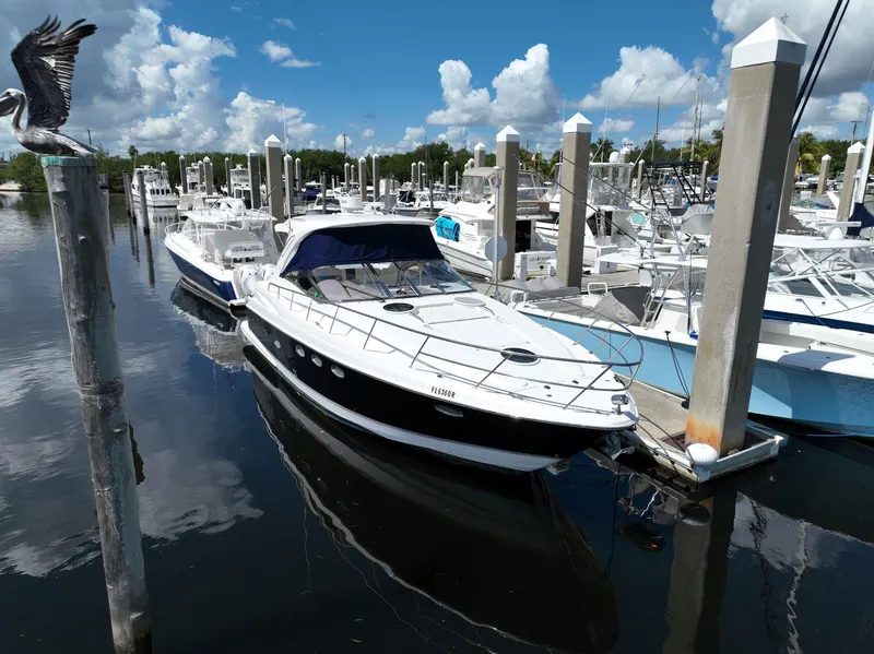 Slide: The Image of 2004 Regal 3860 Commodore yacht docked at a marina on a sunny day. - 2