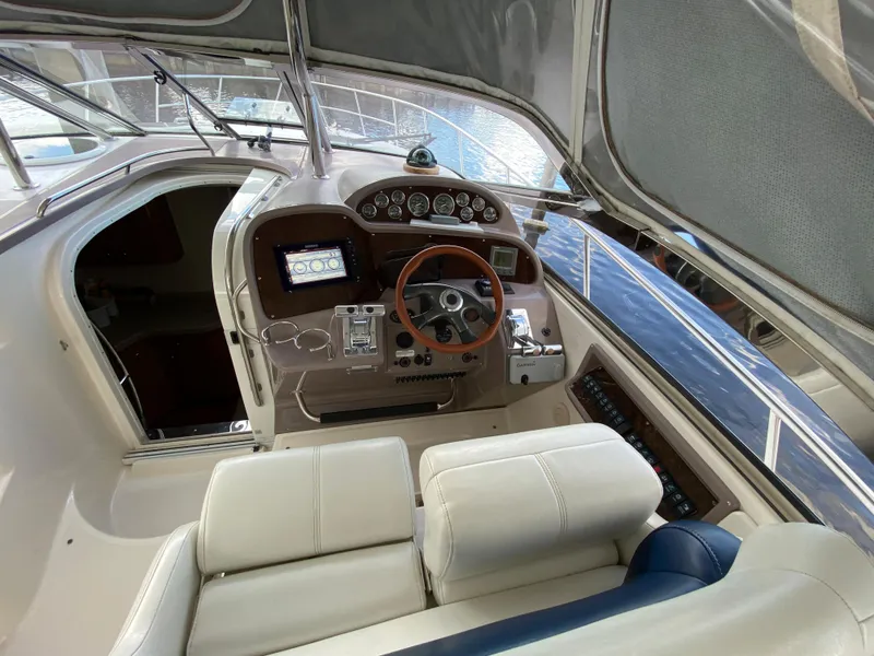 Slide: The Image of 2004 Regal 3860 Commodore yacht helm with modern navigation equipment and leather seating. - 22