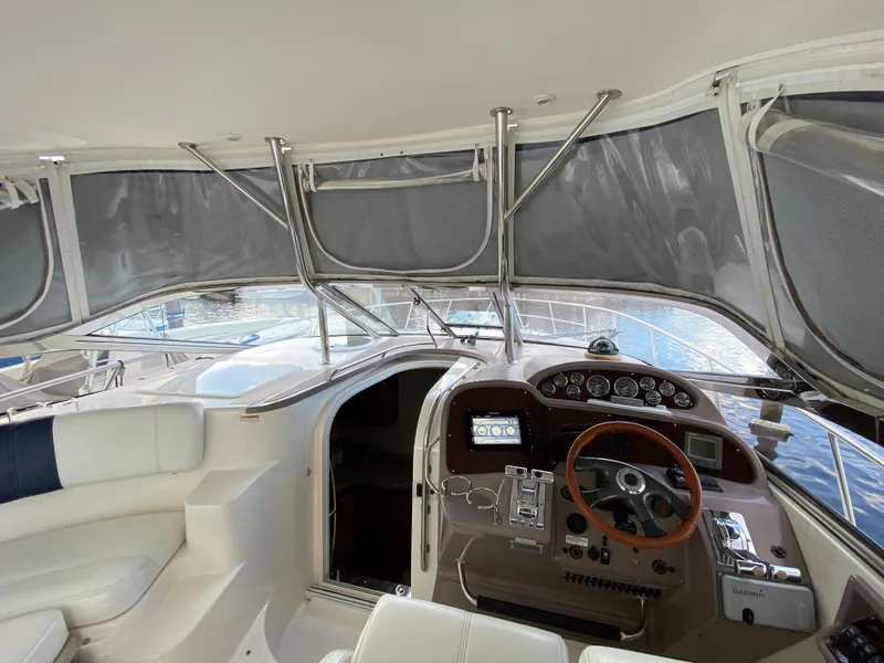 Slide: The Image of 2004 Regal 3860 Commodore yacht interior with helm and seating area. - 23