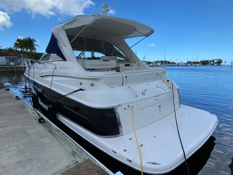 Slide: The Image of 2004 Regal 3860 Commodore yacht docked at marina. - 24