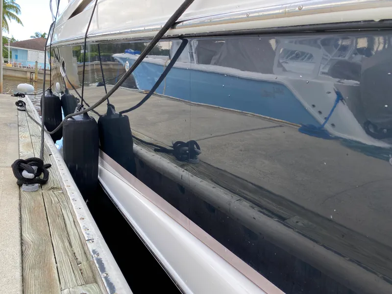 Slide: The Image of Side view of a 2004 Regal 3860 Commodore yacht docked at a marina. - 25