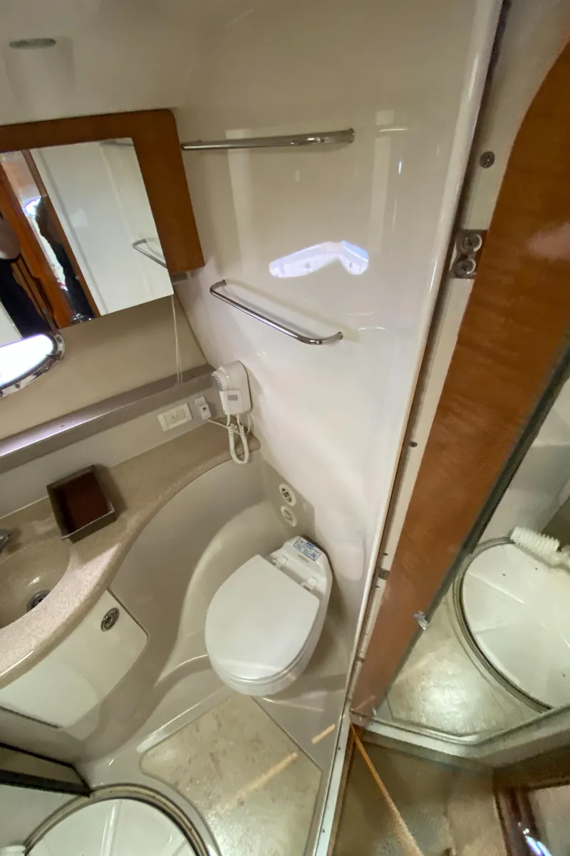 Slide: The Image of 2004 Regal 3860 Commodore yacht bathroom with toilet, sink, and mirror. - 27