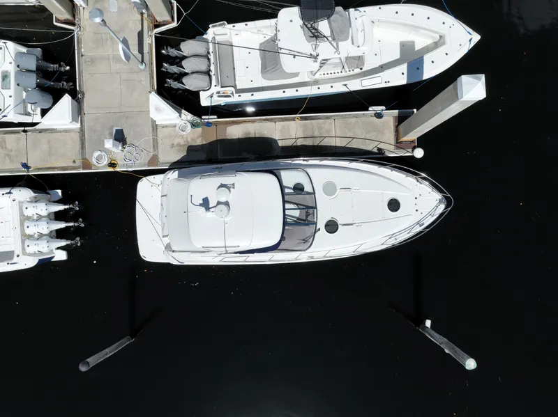 Slide: The Image of Aerial view of a 2004 Regal 3860 Commodore yacht docked at a marina. - 3