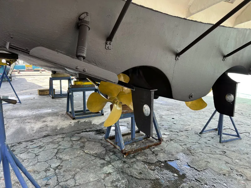 Slide: The Image of 2004 Regal 3860 Commodore boat propellers and hull on stands. - 32