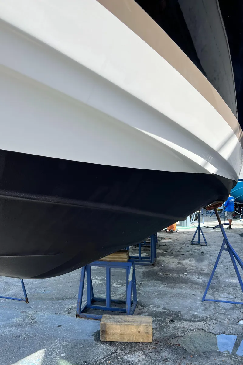 Slide: The Image of 2004 Regal 3860 Commodore boat hull on stands in a boatyard. - 36