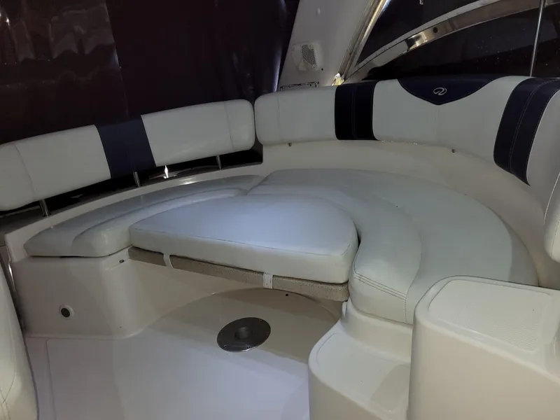 Slide: The Image of 2004 Regal 3860 Commodore boat interior with white and black cushioned seating. - 40