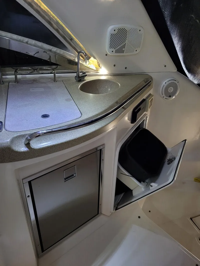 Slide: The Image of 2004 Regal 3860 Commodore yacht kitchenette with sink and storage. - 44