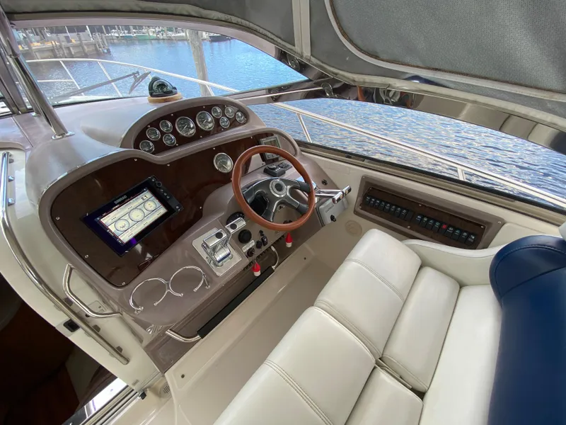 Slide: The Image of 2004 Regal 3860 Commodore yacht helm with modern navigation system and leather seating. - 8