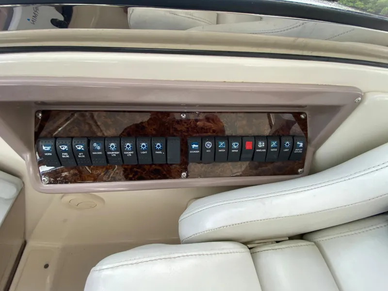 Slide: The Image of Control panel of a 2004 Regal 3860 Commodore boat with labeled switches. - 9