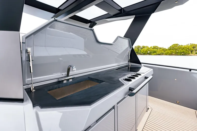 Slide: The Image of Outdoor kitchen area on the 2022 Vanquish Yachts VQ40 with sink and stove. - 12