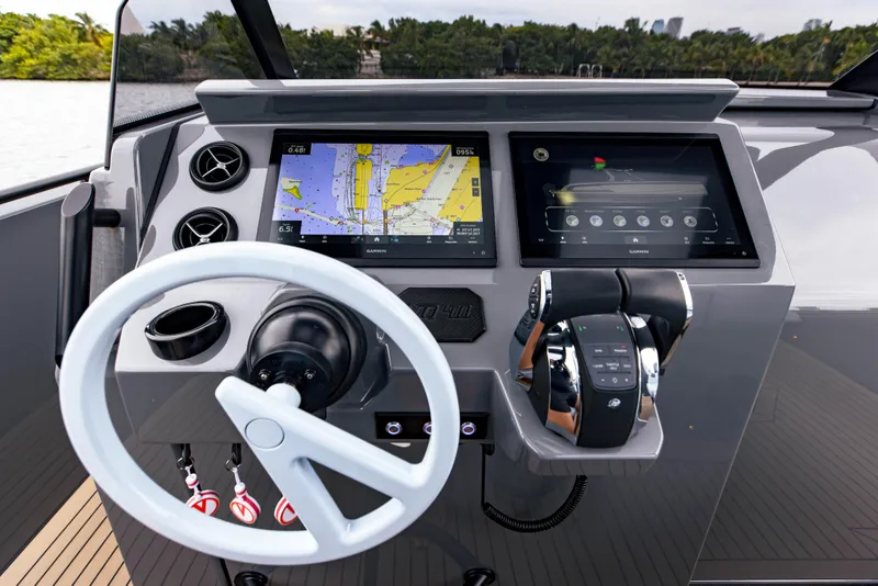 Slide: The Image of Helm of 2022 Vanquish Yachts VQ40 with navigation screens and controls. - 18