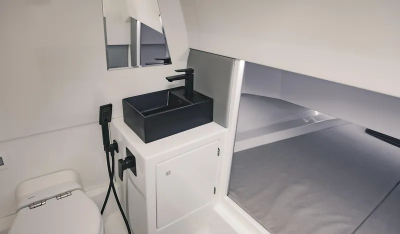Slide: The Image of Modern bathroom interior of 2022 Vanquish Yachts VQ40 with sleek black sink and white fixtures. - 19