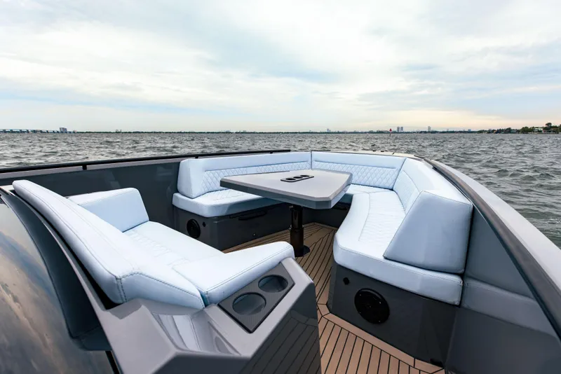 Slide: The Image of Luxurious seating area on the 2022 Vanquish Yachts VQ40, cruising on open water. - 8