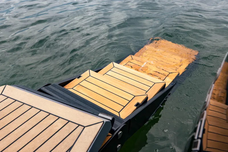 Slide: The Image of Vanquish Yachts VQ40 2022 model with teak swim platform steps in water. - 11