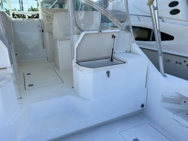 Slide: The Image of 2000 Cabo 35 Express boat interior with white seating and clear enclosures. - 10