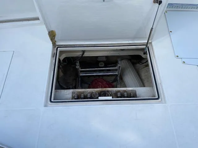 Slide: The Image of 2000 Cabo 35 Express boat interior with white seating and storage compartments. - 12