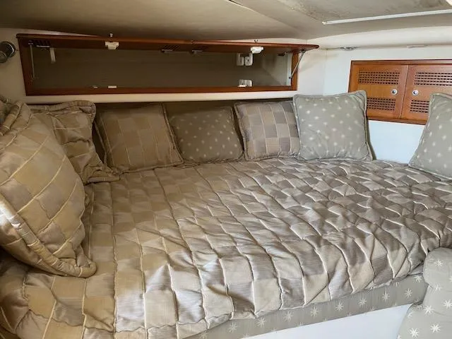 Slide: The Image of Interior of 2000 Cabo 35 Express with white leather seating and wooden cabinetry. - 17