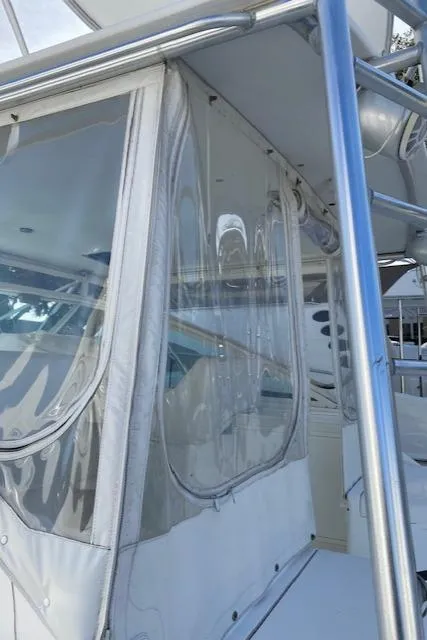 Slide: The Image of Top deck of a 2000 Cabo 35 Express boat in a marina. - 23