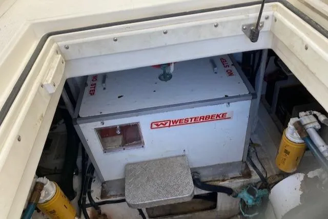 Slide: The Image of 2000 Cabo 35 Express boat interior with covered seating and storage cabinets. - 27