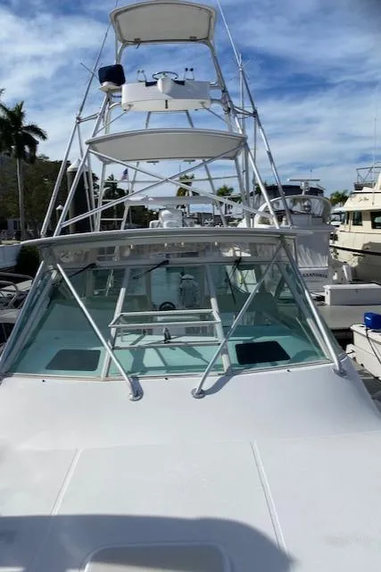 Slide: The Image of 2000 Cabo 35 Express boat with black storage compartment and steering wheel. - 38
