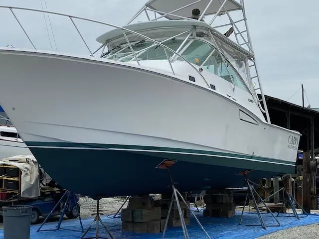 Slide: The Image of 2000 Cabo 35 Express boat docked at a marina. - 42