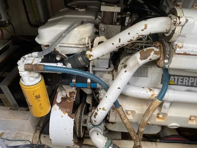 Slide: The Image of Engine room of a 2000 Cabo 35 Express boat with visible fuel filters and ladder. - 45