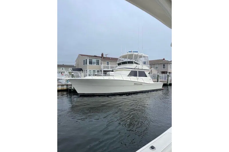 The Image of 1989 Viking 41 Sportfish Convertible yacht docked in a residential marina. - 0