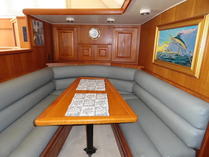 Slide: The Image of Interior of 1989 Viking 41 Sportfish Convertible with wooden table and artwork. - 10