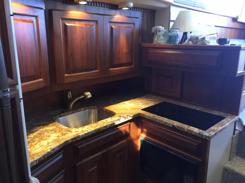 Slide: The Image of 1989 Viking 41 Sportfish Convertible kitchen with wooden cabinets. - 13