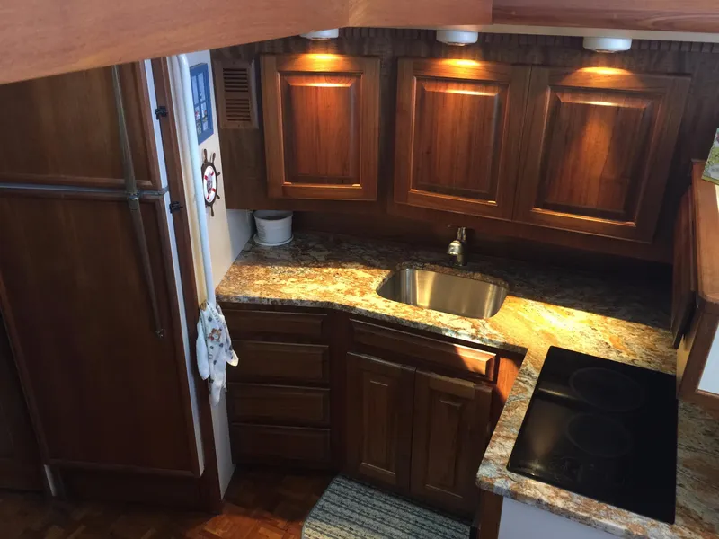Slide: The Image of 1989 Viking 41 Sportfish Convertible kitchen with wooden cabinets. - 14