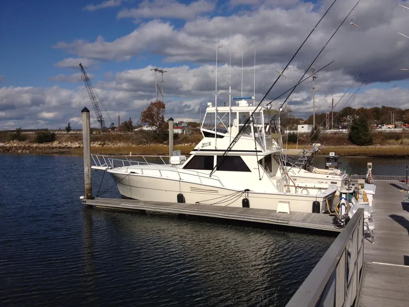 Slide: The Image of 1989 Viking 41 Sportfish Convertible docked, serene water setting. - 15