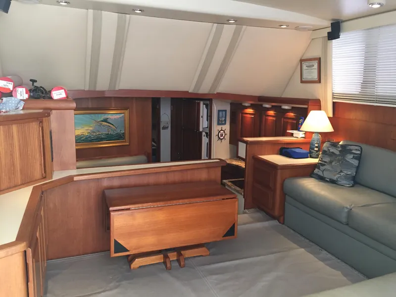 Slide: The Image of Interior of 1989 Viking 41 Sportfish Convertible with wooden furniture and cozy lighting. - 18