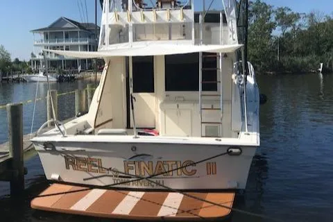 Slide: The Image of 1989 Viking 41 Sportfish Convertible at dock, rear view. - 42