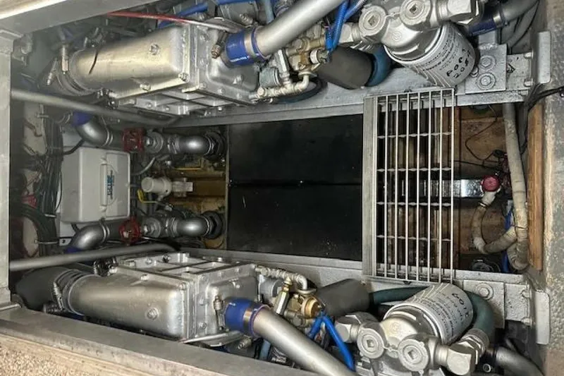 Slide: The Image of Engine room of a 1989 Viking 41 Sportfish Convertible boat, showcasing mechanical components. - 43