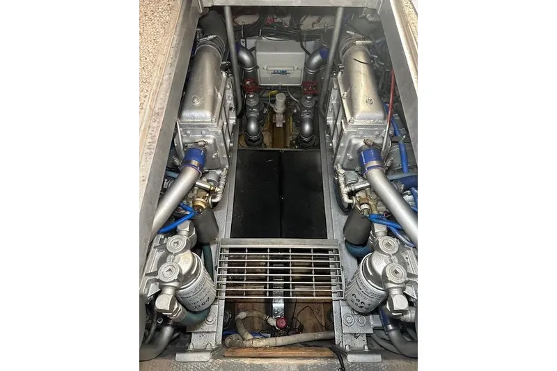 Slide: The Image of Engine room of a 1989 Viking 41 Sportfish Convertible boat, showcasing dual engines. - 44